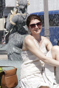 Statue of man and woman sitting by sculpture