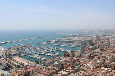 High angle view of buildings by sea against sky
