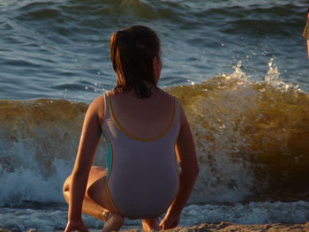 Rear view of woman at beach