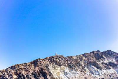 Cliff and lighthouse on the southern of thira island in greek islands on a clear, sunny day