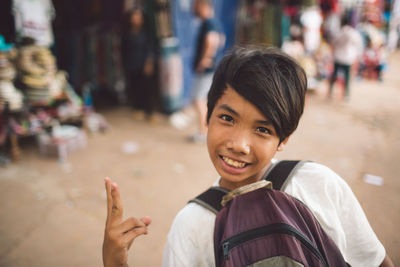 Portrait of smiling boy on street in city