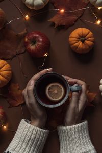 Midsection of person holding coffee cup