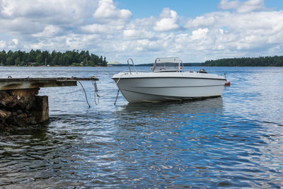 Boats moored on sea against sky