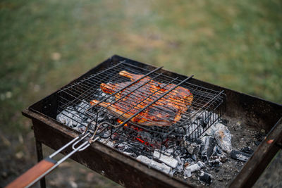 High angle view of meat on barbecue grill