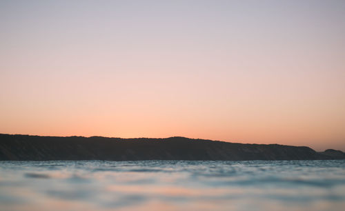 Scenic view of sea against clear sky during sunset