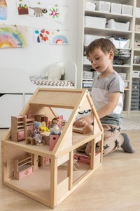 Side view of boy playing with toy blocks