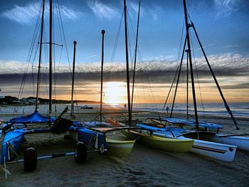 Sailboat in sea against cloudy sky