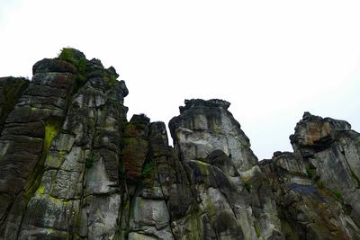 Low angle view of rock formation against clear sky