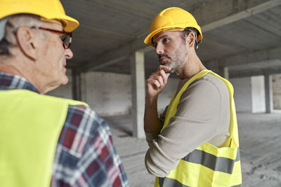 Engineers having discussion at construction site
