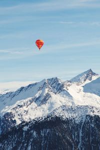 Scenic view of snow covered mountains against sky