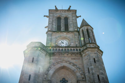 Low angle view of clock tower against sky