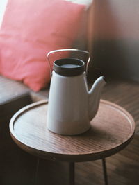 Close-up of teapot on side table