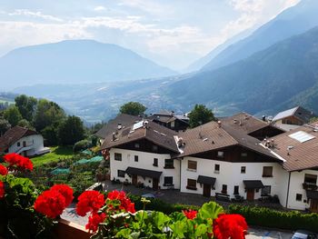 Scenic view of houses and mountains against sky