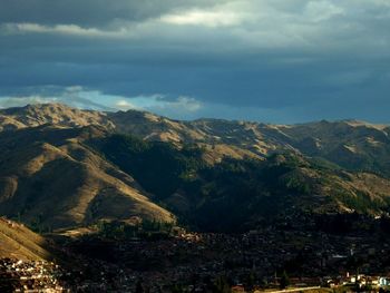 Scenic view of mountains against cloudy sky