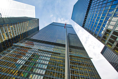 Low angle view of modern buildings against sky in city