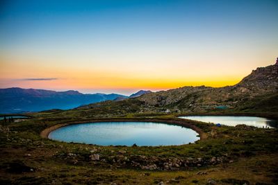 Scenic view of river against sky during sunset