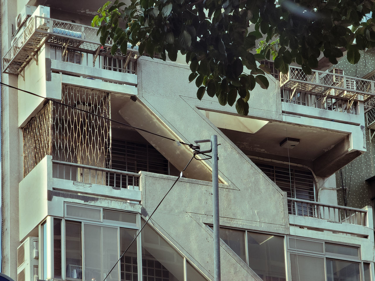 architecture, built structure, building exterior, building, house, facade, residential district, no people, city, home, tree, urban area, railing, low angle view, window, plant, day, staircase, outdoors, nature, residential area, steps and staircases