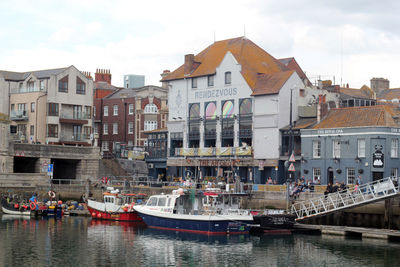 Boats moored at harbor