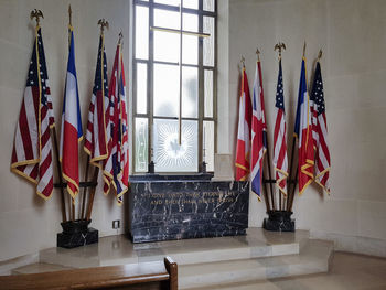 Various flags hanging in the wall