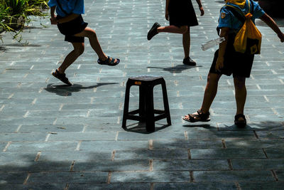 Low section of people walking on street