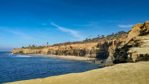 Scenic view of beach against blue sky