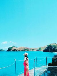 Rear view of woman looking at sea against sky