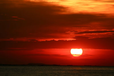 Scenic view of sea against romantic sky at sunset