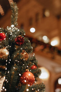 Red shiny christmas balls hanging on the christmas tree. new year's details 