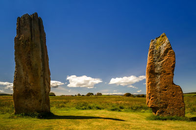 Built structure on field against blue sky