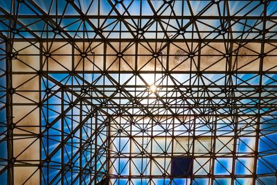 Low angle view of glass building against sky