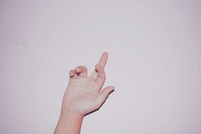 Close-up of human hand over white background