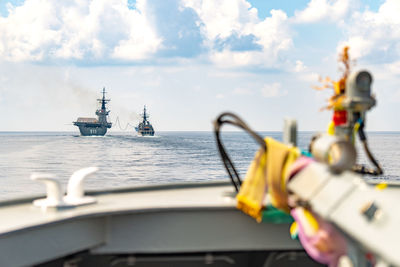 Ship sailing in sea against sky