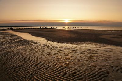 Scenic view of beach against sky during sunset