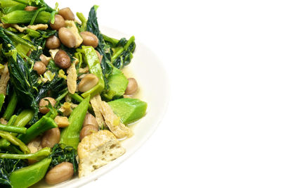 Close-up of vegetables in bowl against white background