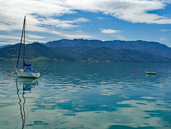 Sailboats in sea against sky