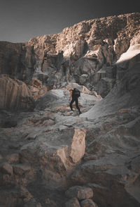 Low angle view of woman climbing on mountain