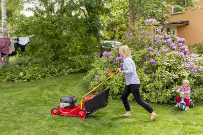 Woman mowing lawn