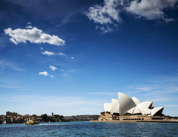 Buildings in city against cloudy sky