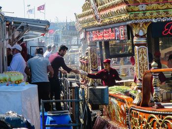 Rear view of people at market stall in city