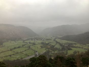 Scenic view of agricultural landscape against sky