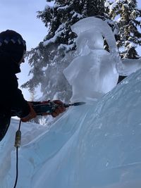 Low angle view of people skiing on snow