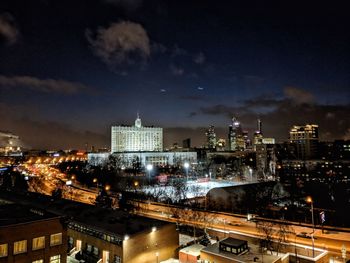 High angle view of city lit up at night