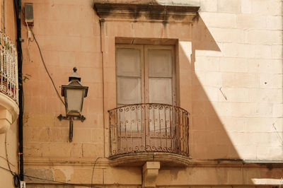 Low angle view of street light against building