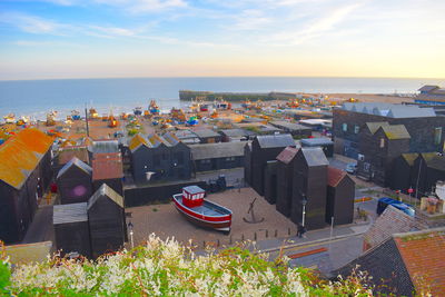 High angle view of buildings by sea against sky