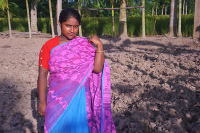 Portrait of a smiling young woman in forest