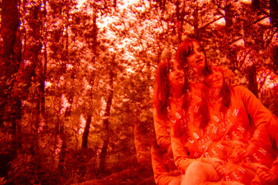 Multiple image of woman against trees in forest