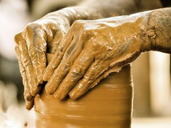 Close-up of person making pot