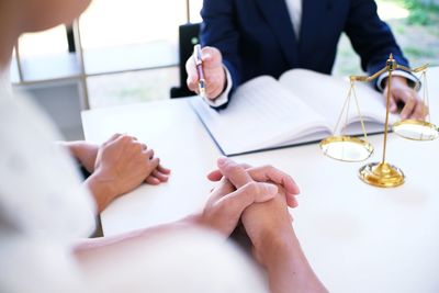 High angle view of lawyer discussing at table in office