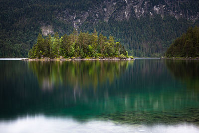 Colorful reflection of sasseninsel located at eibsee lake in the alps mountains in bavaria germany