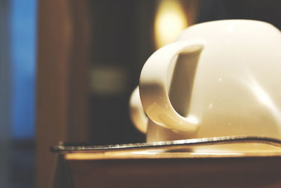 Close-up of illuminated light bulb on table